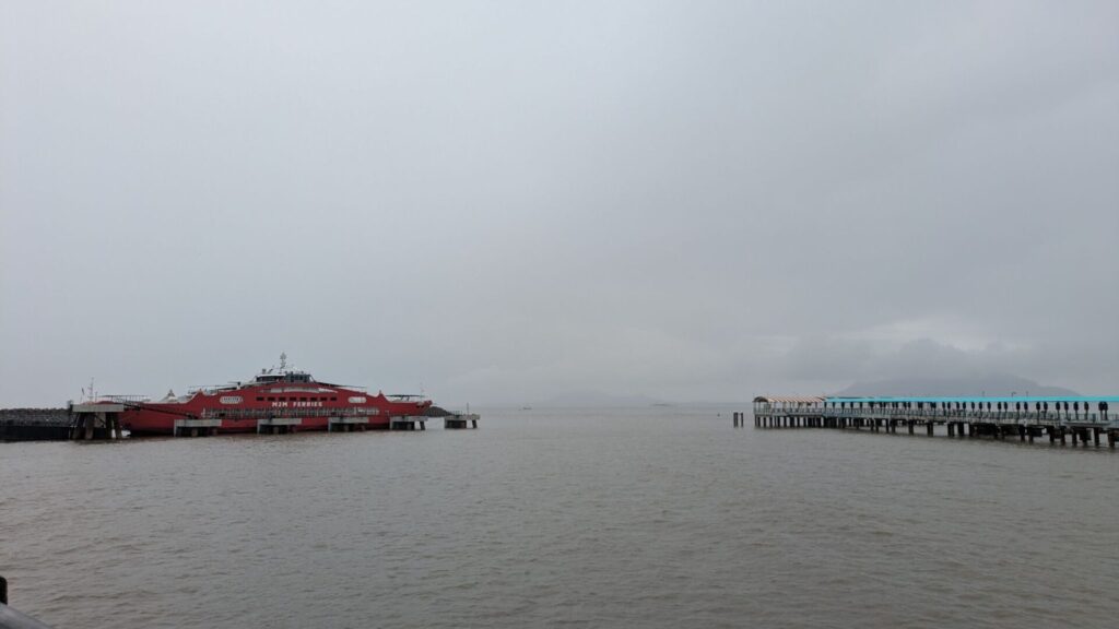 In Alibaug Scenic harbor with ferry terminal and wooden jetty by isprava.