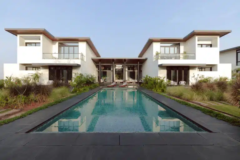 Exterior view of a Heritage Collection luxury villa in Alibaug surrounded by lush greenery